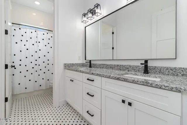 a bathroom with a granite countertop sink a mirror and a