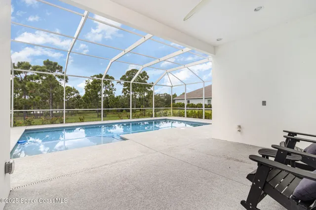 a view of a swimming pool with a porch in front of it