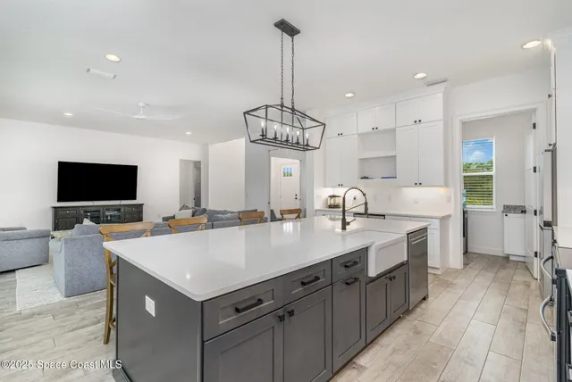 a view of a kitchen counter space a sink stainless steel appliances and cabinets