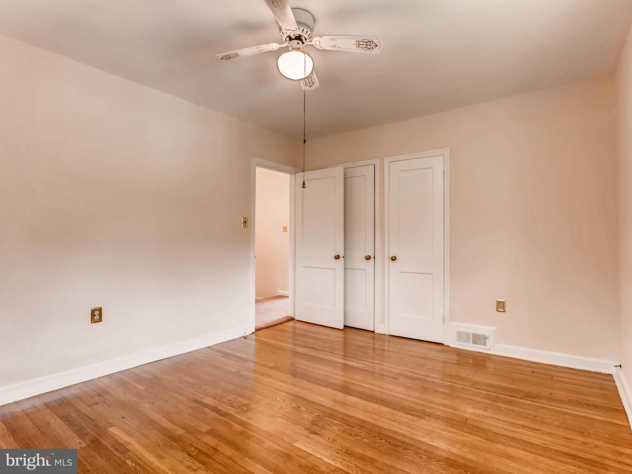 1316 Silverthorne Road Baltimore, MD 21239 - Photo 14 of 27 a view of an empty room with wooden floor