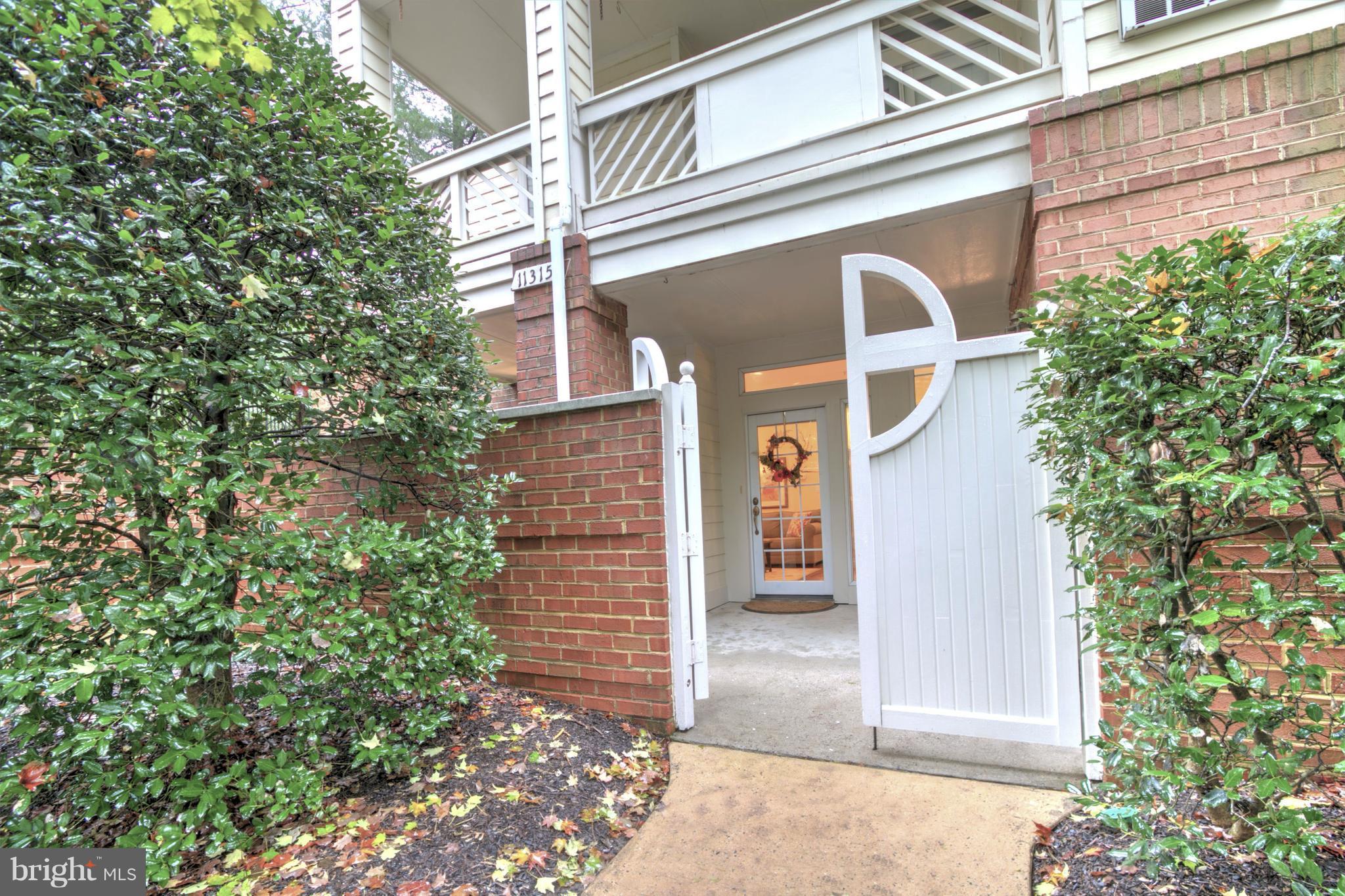 11315 Sundial Court, Unit 212 Reston, VA 20194 - Photo 1 of 18 a view of a brick house with plants