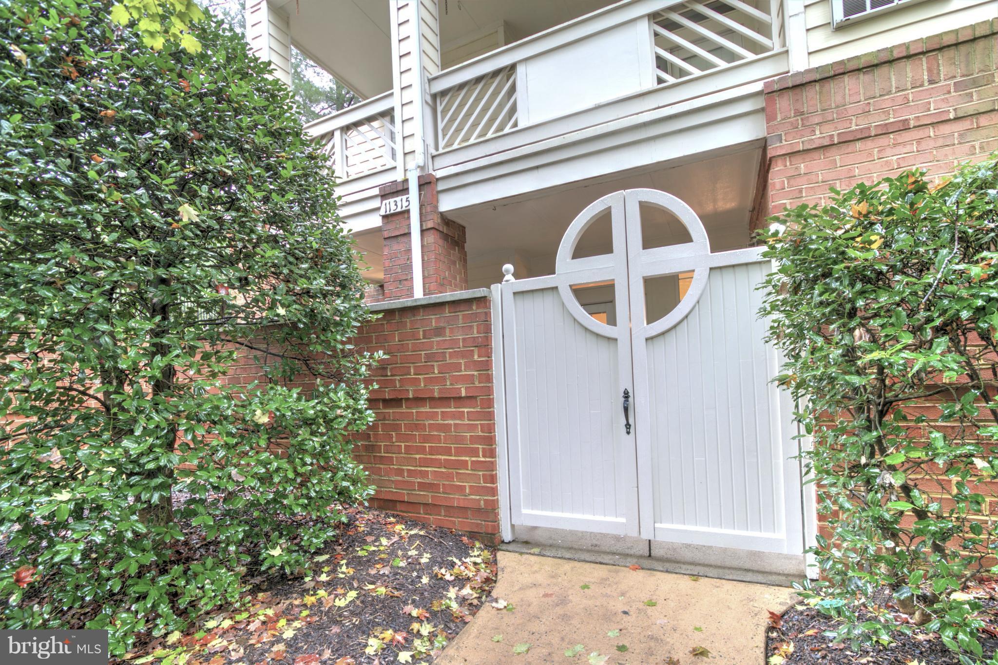 11315 Sundial Court, Unit 212 Reston, VA 20194 - Photo 16 of 18 a front view of a house with a garden