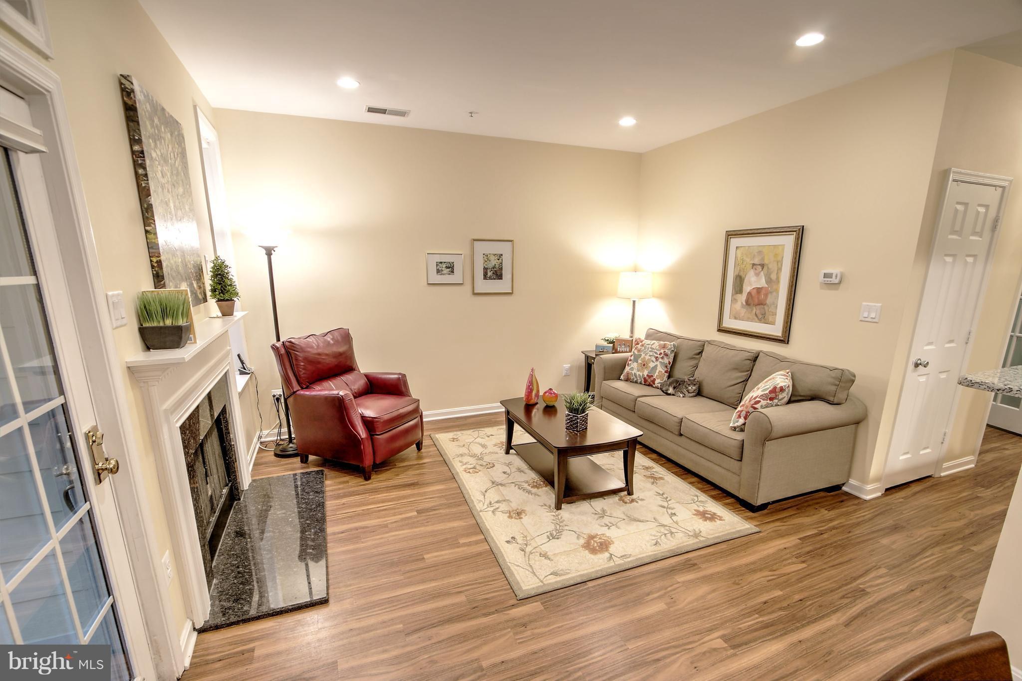 11315 Sundial Court, Unit 212 Reston, VA 20194 - Photo 3 of 18 a living room with furniture and a fireplace