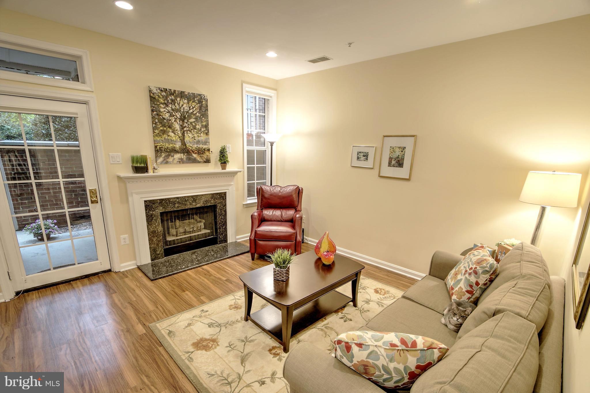 11315 Sundial Court, Unit 212 Reston, VA 20194 - Photo 4 of 18 a living room with furniture and a fireplace