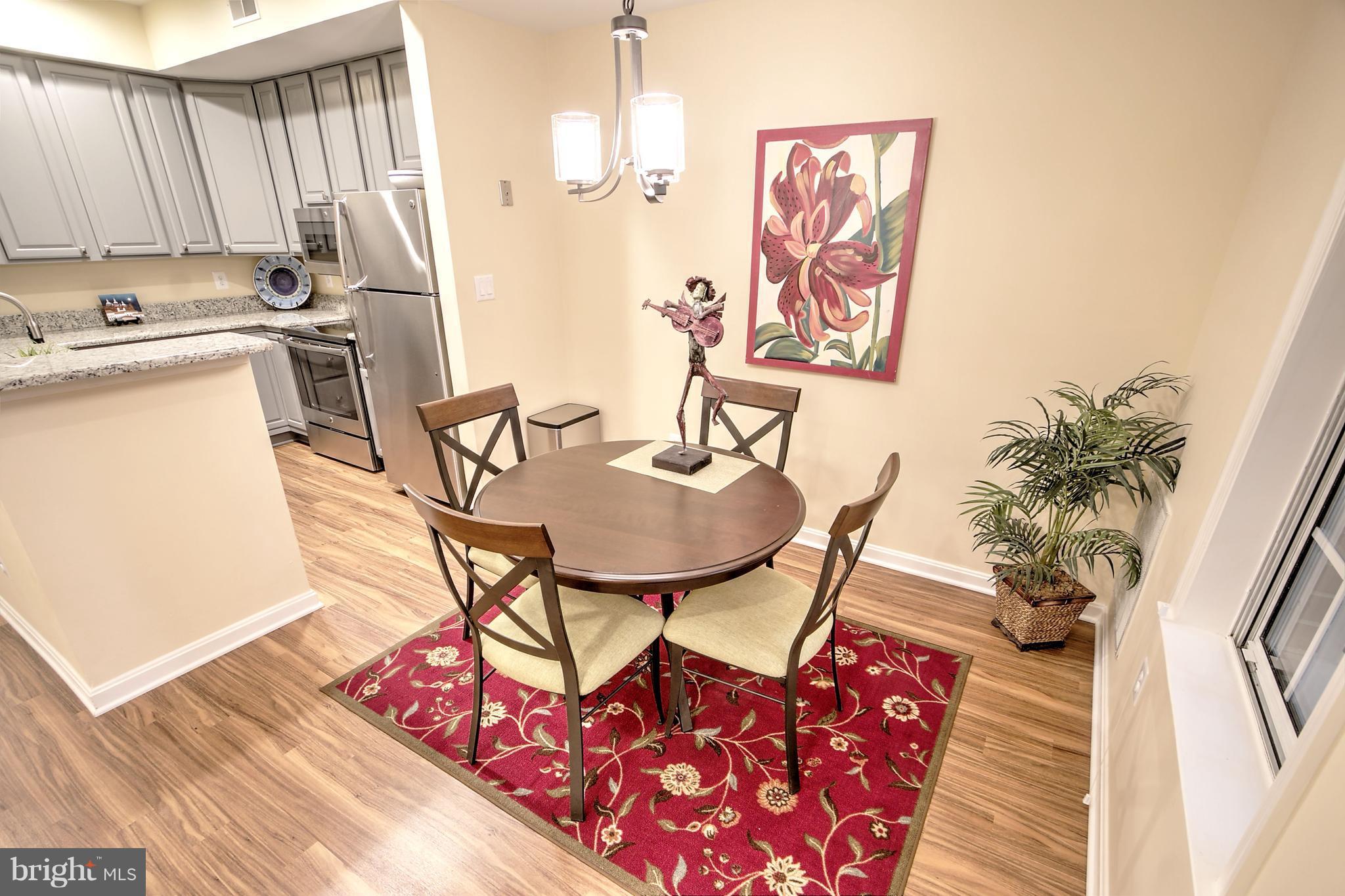 11315 Sundial Court, Unit 212 Reston, VA 20194 - Photo 5 of 18 a dining room with furniture and wooden floor
