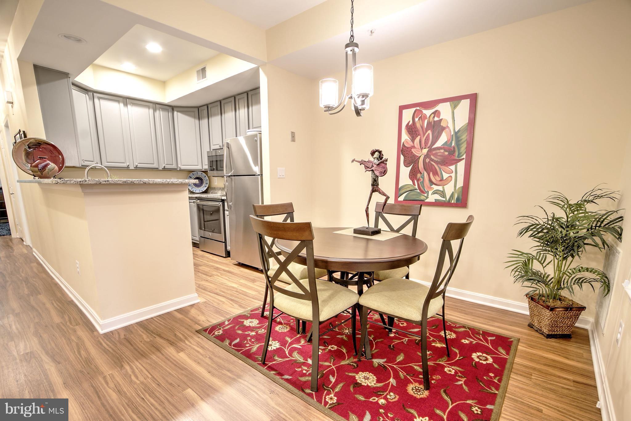 11315 Sundial Court, Unit 212 Reston, VA 20194 - Photo 7 of 18 a living room with furniture and a table