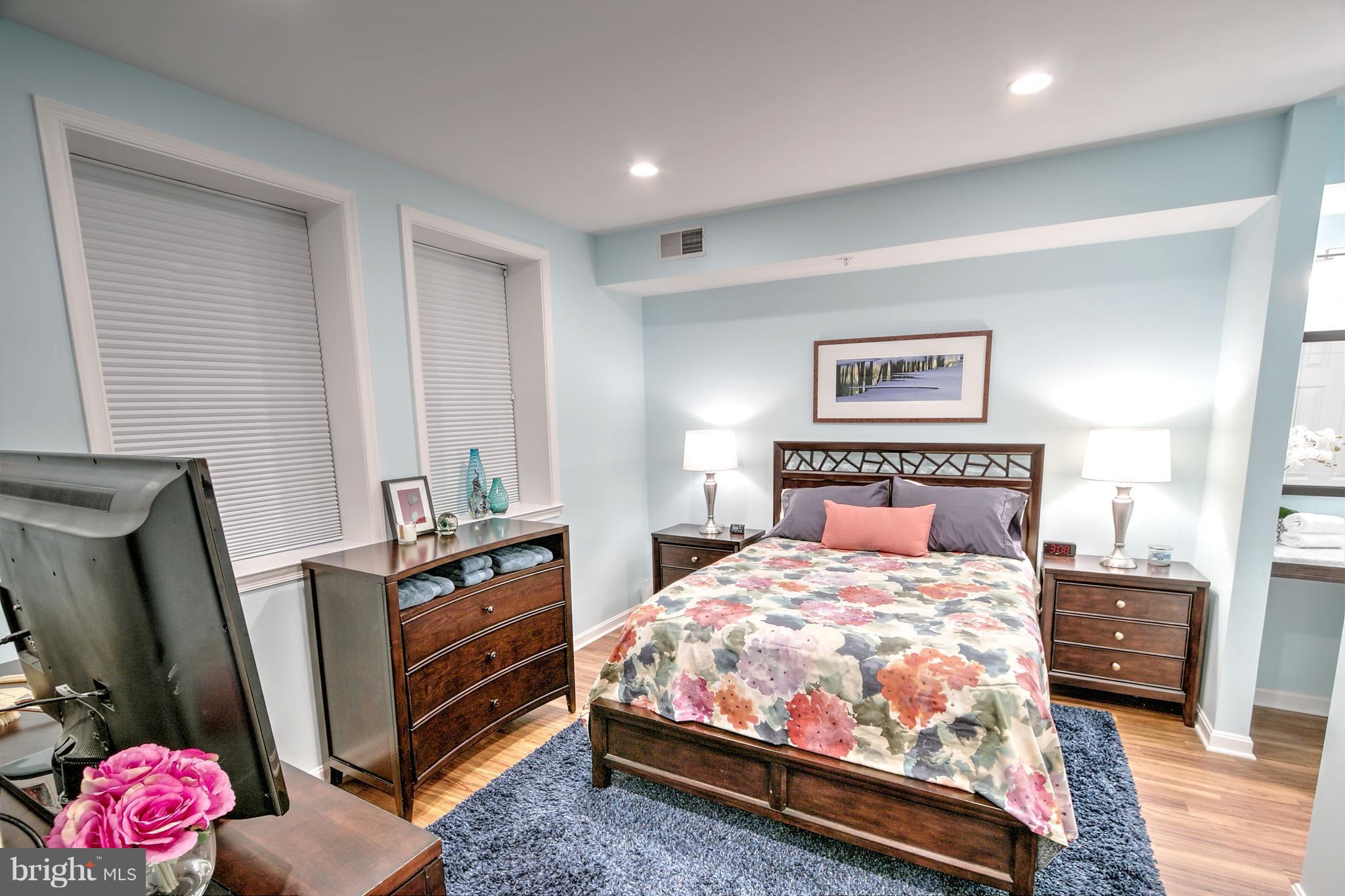 11315 Sundial Court, Unit 212 Reston, VA 20194 - Photo 10 of 18 a bedroom with a bed and a dresser