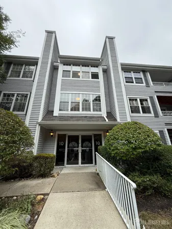 a front view of a building with a yard