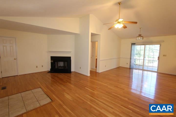 376 North Ridge Way Ruckersville, VA 22968 - Photo 2 of 16 a view of an empty room with wooden floor and a fireplace