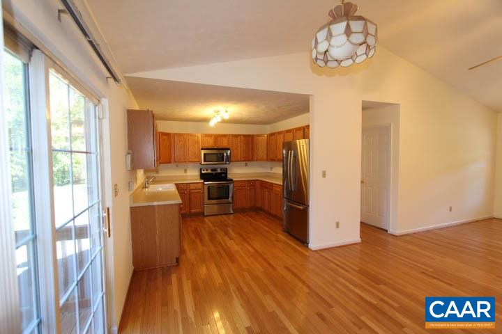 376 North Ridge Way Ruckersville, VA 22968 - Photo 4 of 16 a kitchen with stainless steel appliances wooden floor and large windows