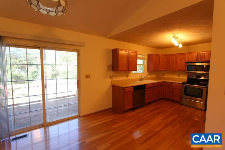 376 North Ridge Way Ruckersville, VA 22968 - Photo 5 of 16 a kitchen with stainless steel appliances kitchen island granite countertop a stove a sink and a refrigerator