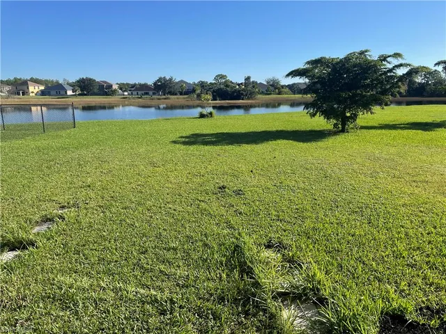 a view of a lake with houses in back