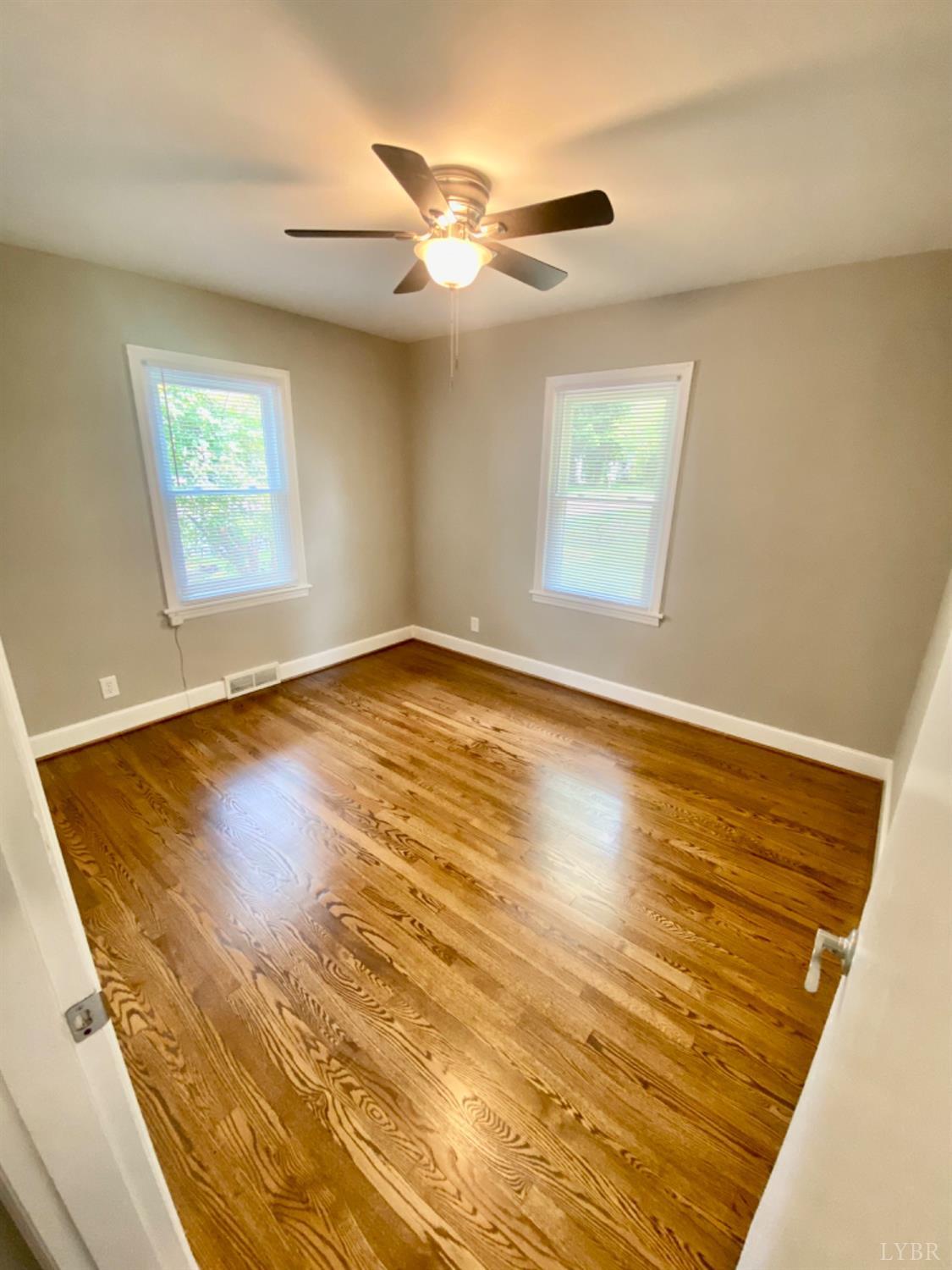 2412 Old Forest Road Lynchburg, VA 24501 - Photo 22 of 29 a view of an empty room with wooden floor and a window
