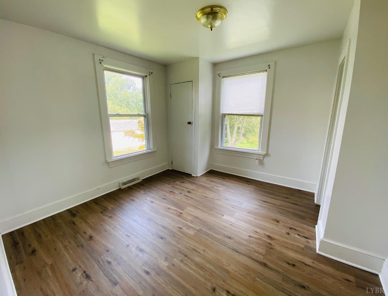 2412 Old Forest Road Lynchburg, VA 24501 - Photo 27 of 29 an empty room with wooden floor and windows