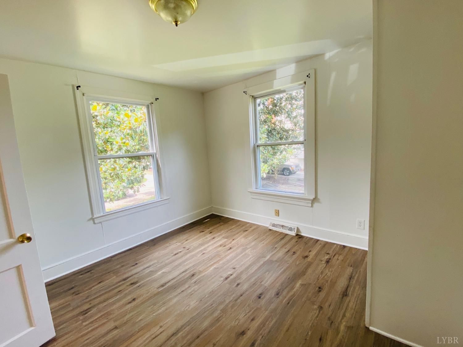 2412 Old Forest Road Lynchburg, VA 24501 - Photo 28 of 29 a view of an empty room with wooden floor and a window