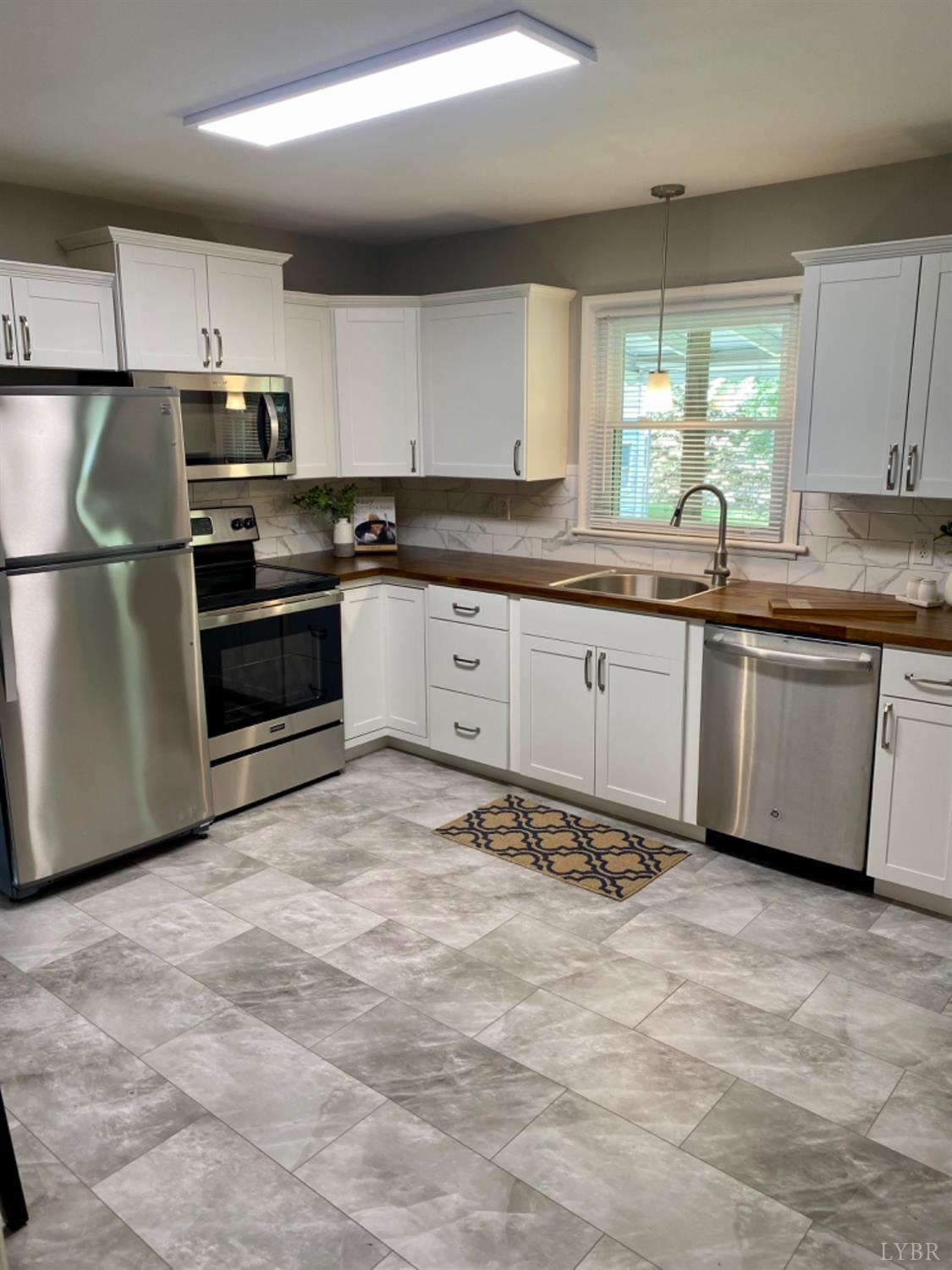 2412 Old Forest Road Lynchburg, VA 24501 - Photo 4 of 29 a large kitchen with cabinets and stainless steel appliances