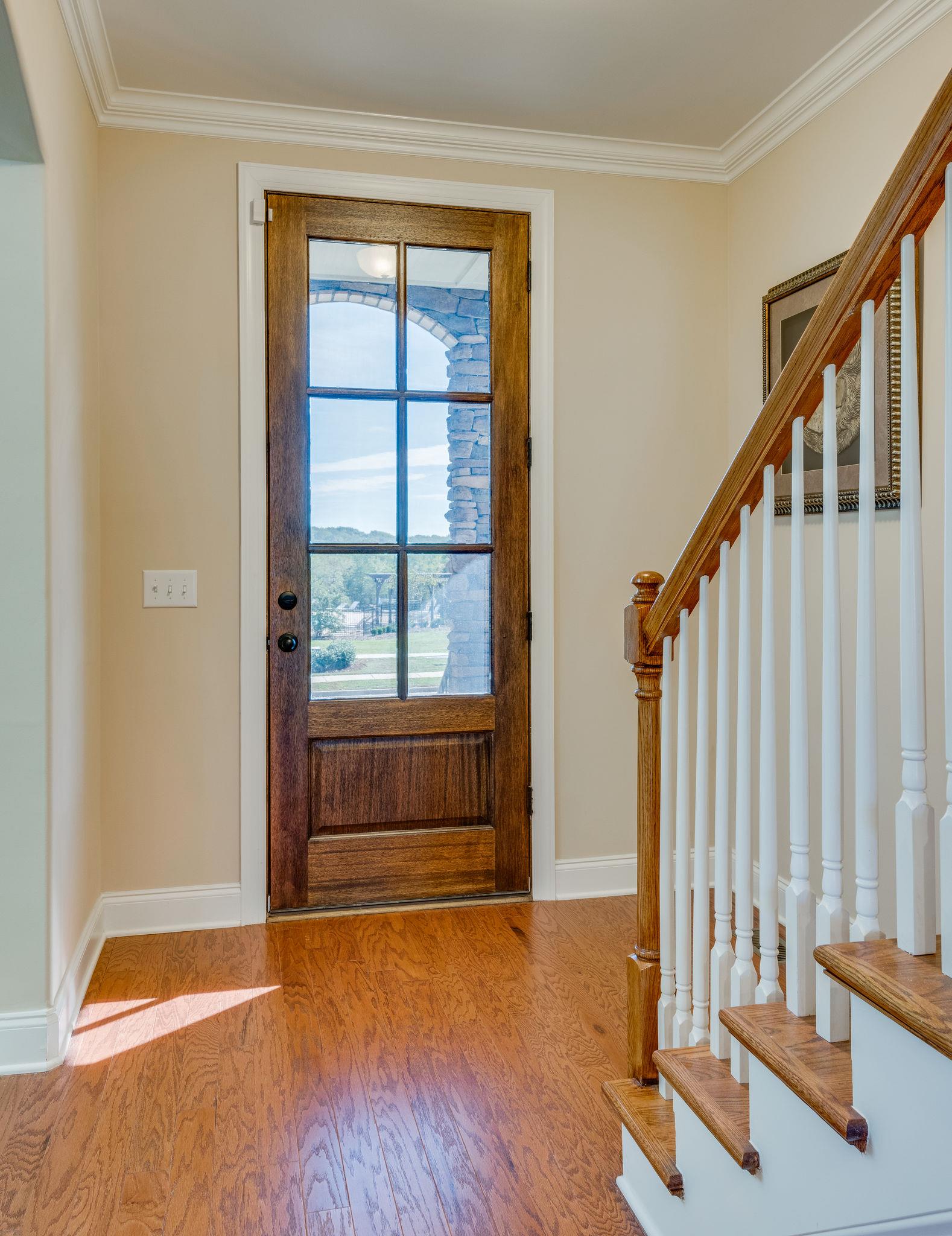 360 Old Stone Road Goodlettsville, TN 37072 - Photo 4 of 28 a view of an empty room with wooden floor and stairs