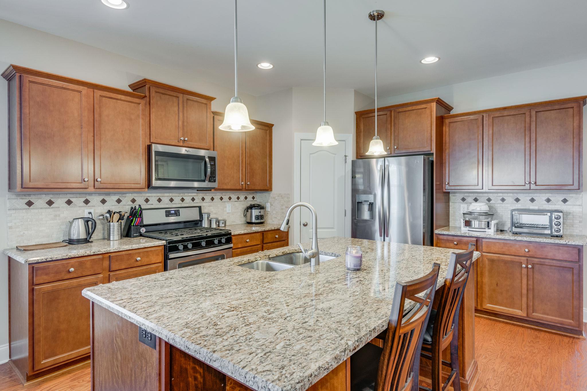 360 Old Stone Road Goodlettsville, TN 37072 - Photo 8 of 28 a kitchen with stainless steel appliances granite countertop a sink refrigerator and microwave