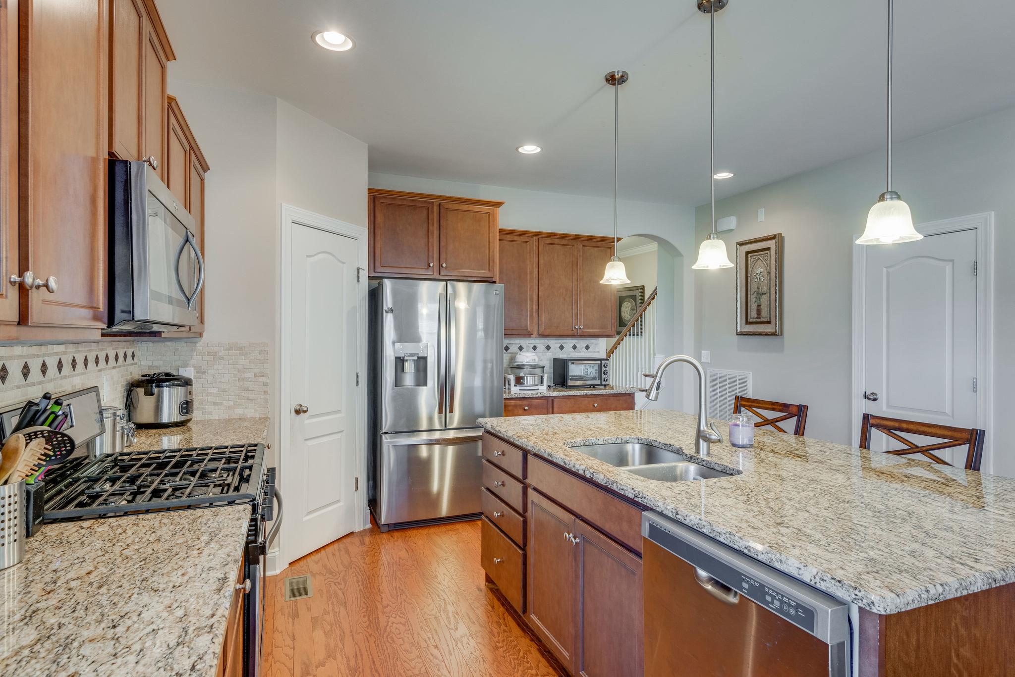 360 Old Stone Road Goodlettsville, TN 37072 - Photo 9 of 28 a kitchen with granite countertop a sink stainless steel appliances and counter space
