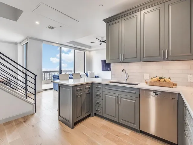 a kitchen with a sink cabinets and window