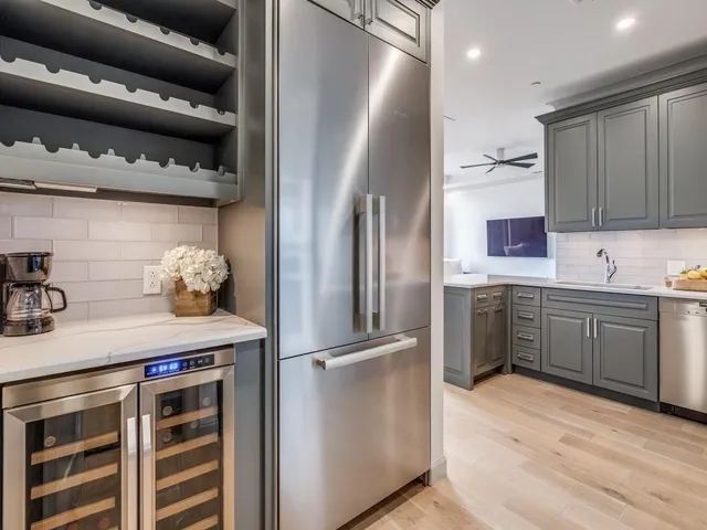 a kitchen with stainless steel appliances a refrigerator and cabinets