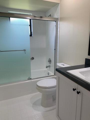 18065 Park Terrace Boca Raton, FL 33498 - Photo 14 of 20 a bathroom with a granite countertop sink toilet and shower