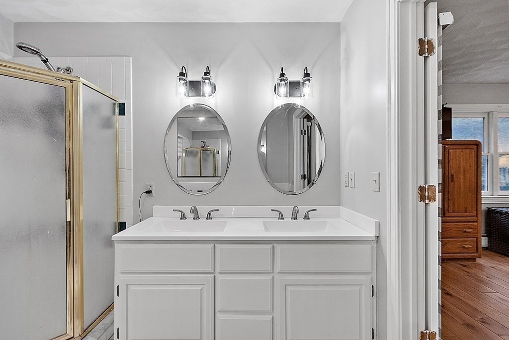 41 Maple Street Pepperell, MA 01463 - Photo 23 of 39 a bathroom with a double vanity sink and a mirror