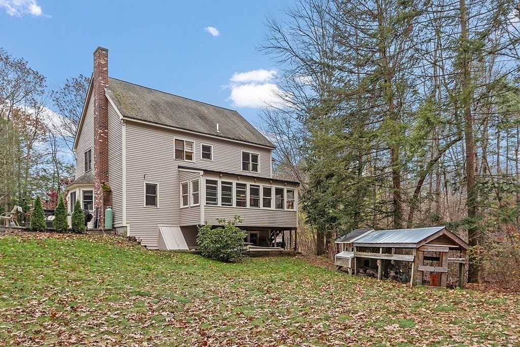 41 Maple Street Pepperell, MA 01463 - Photo 35 of 39 a backyard of a house with garden and trees