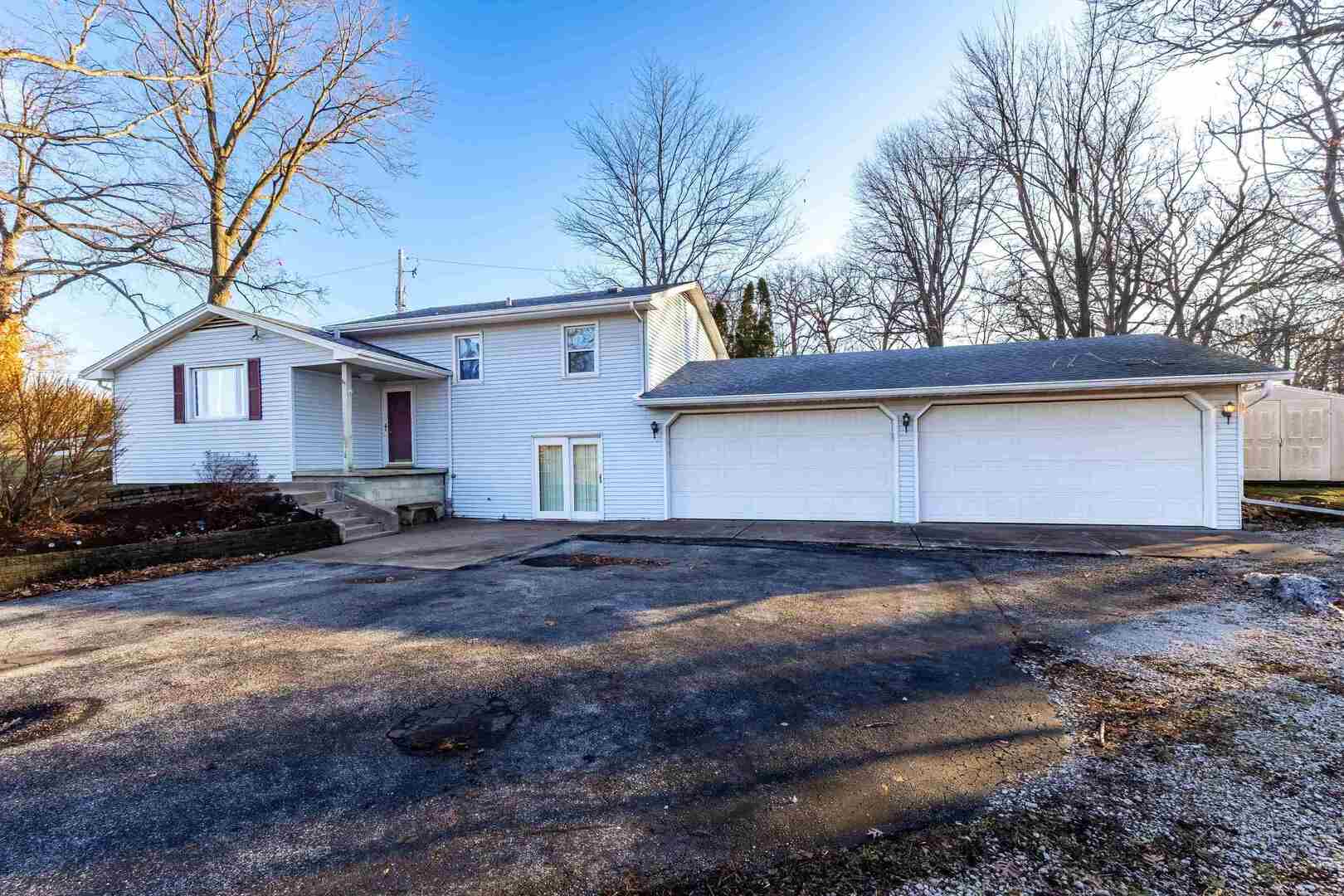 a view of a house with a yard covered with snow