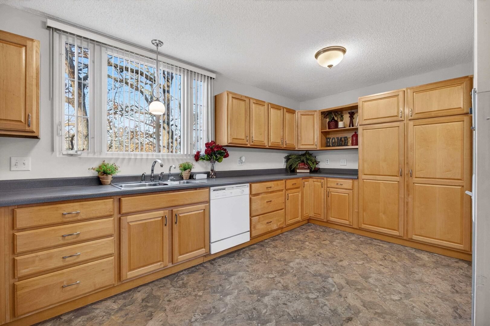 4318 5th Street East Moline, IL 61244 - Photo 11 of 30 a kitchen with granite countertop a refrigerator sink and cabinets