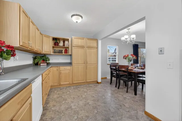 a view of a dining room with furniture and chandelier