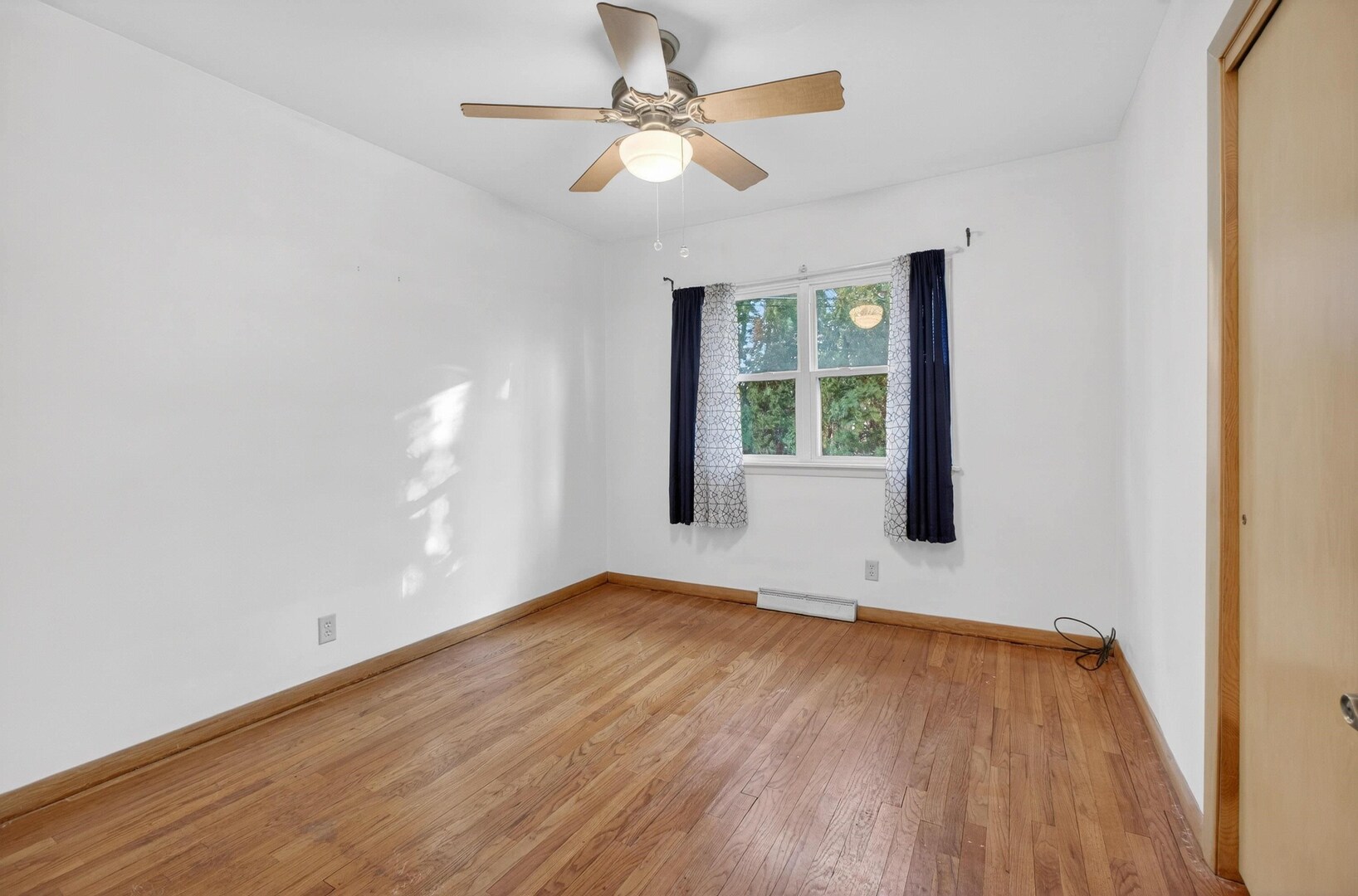 4318 5th Street East Moline, IL 61244 - Photo 15 of 30 a view of an empty room with wooden floor and a window