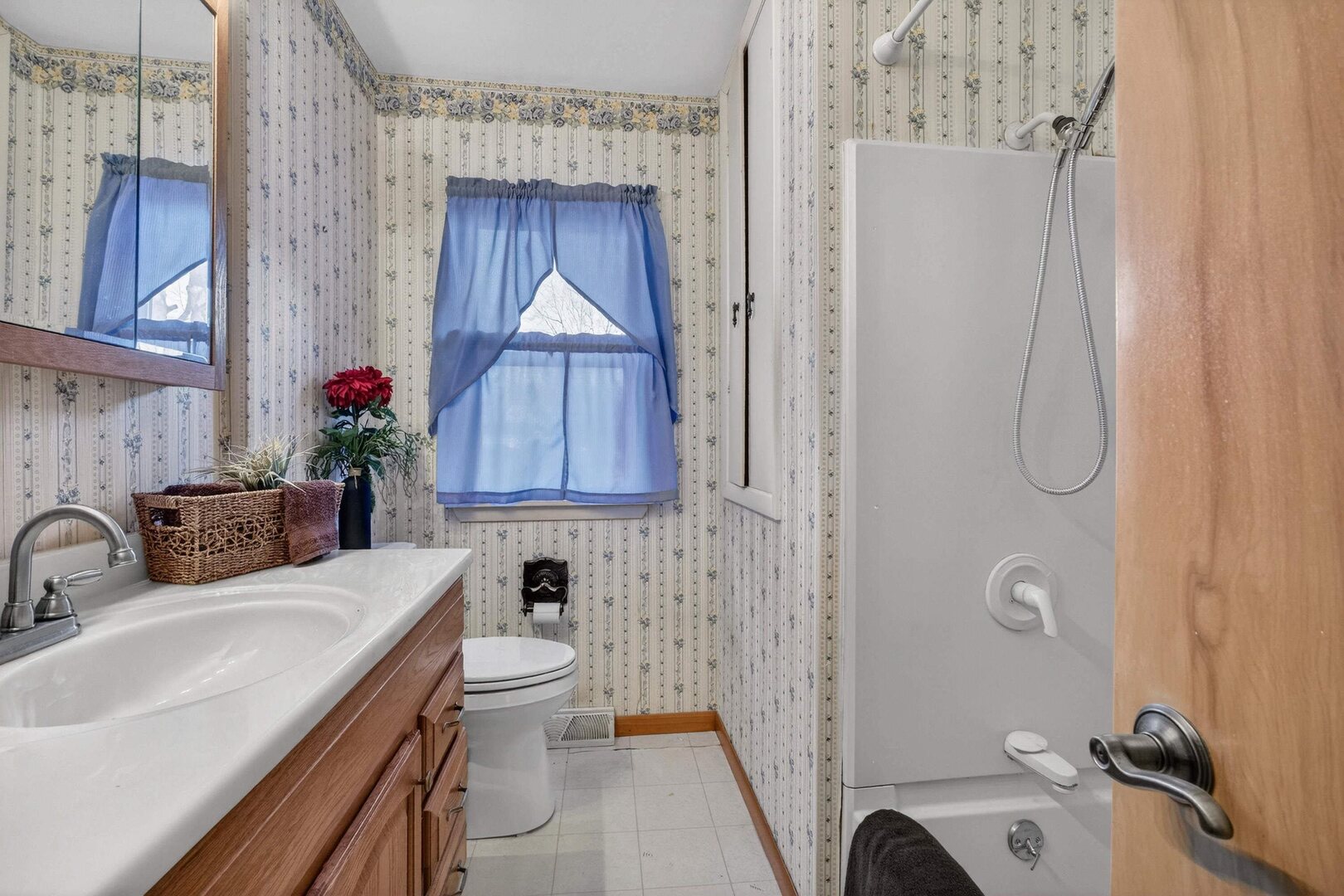 4318 5th Street East Moline, IL 61244 - Photo 17 of 30 a bathroom with a sink a toilet and shower curtain