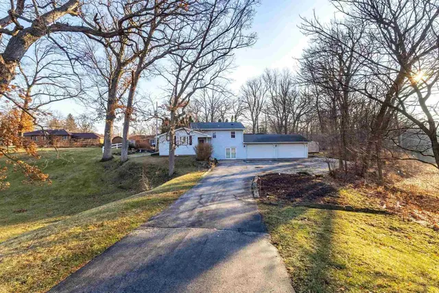 a house view with a swimming pool next to a yard