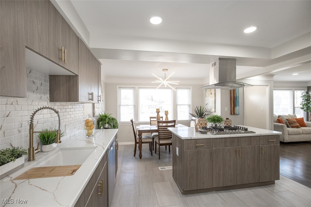 4631 Belfiore Road Cleveland, OH 44128 - Photo 27 of 28 Kitchen with a kitchen island, open floor plan, modern cabinets, island exhaust hood, and recessed lighting