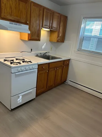 a kitchen with granite countertop a stove and a sink
