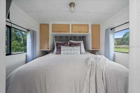 a bedroom with a bed and window