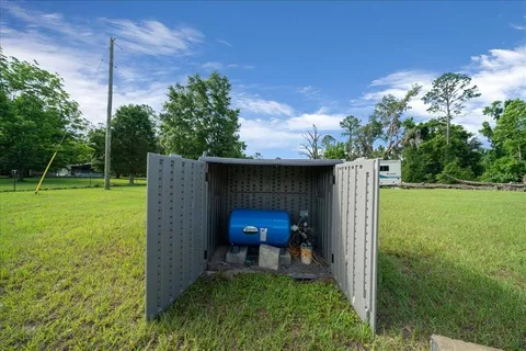 a view of a chair and table in the garden