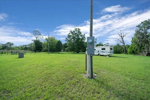 a view of a field with a tree in the background