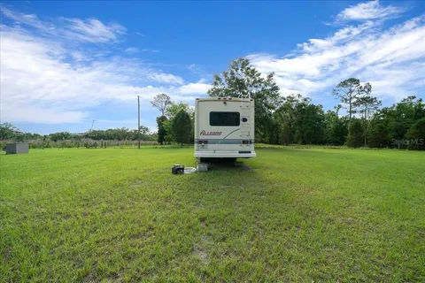 a view of a garden with lawn chairs