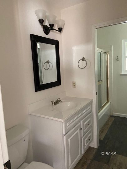 1010 Peg Street Ridgecrest, CA 93555 - Photo 12 of 17 a bathroom with a toilet sink and mirror