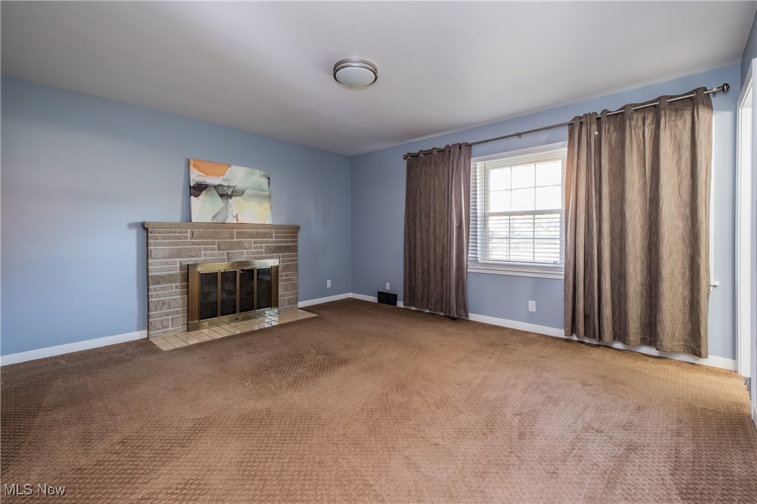 604 Everhard Road Southwest North Canton, OH 44709 - Photo 9 of 24 Owners Bedroom with carpet and a fireplace