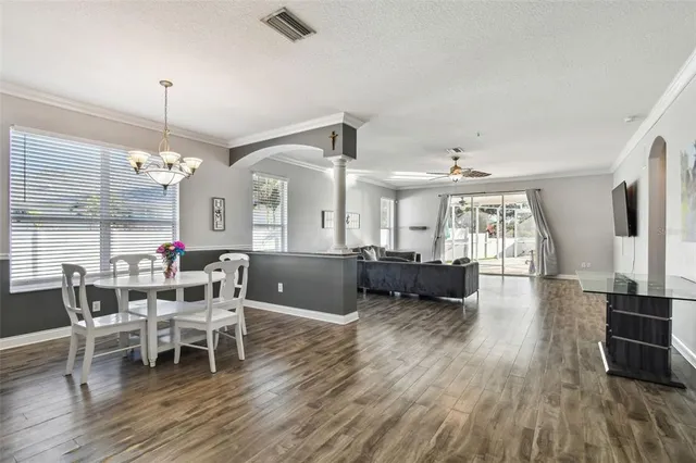 a view of a dining room with furniture and wooden floor