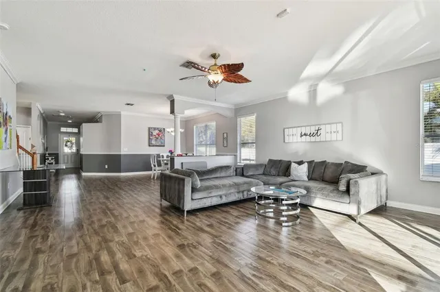 a kitchen with stainless steel appliances granite countertop a stove top oven a sink dishwasher a refrigerator and cabinets with wooden floor