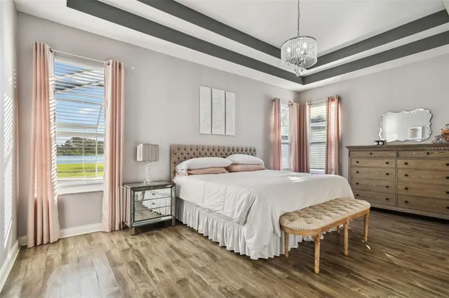 a bathroom with a granite countertop sink vanity mirror and toilet