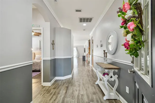 a view of a dining room with furniture a chandelier and wooden floor