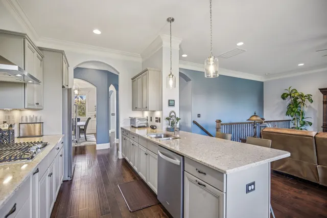 a kitchen with granite countertop a stove and cabinets