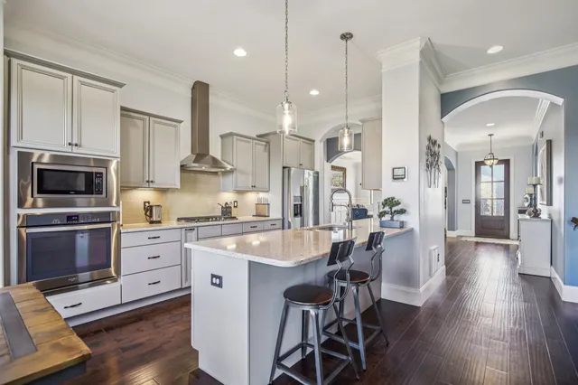 a large kitchen with a table and chairs