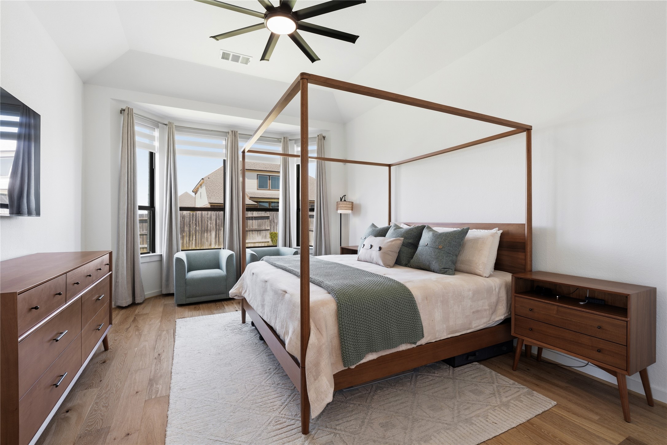 416 Bartlett Street Webster, TX 77598 - Photo 21 of 49 Primary suite with four-poster canopy bed, wood floors, and ceiling fan