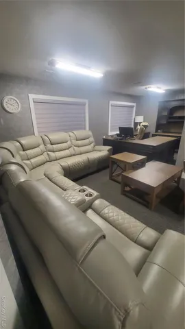 a living room with furniture and a lamp